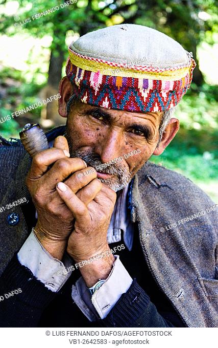 Portrait of Himachali man smoking chillum at Rumsu village, Nagar, Himachal Pradesh, India