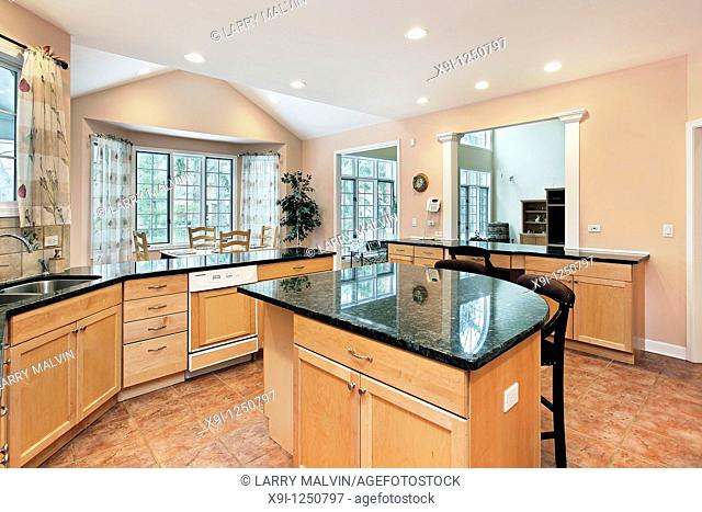 Kitchen in luxury home with marble top island