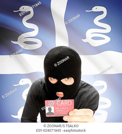 Hacker with flag on background holding ID card in hand - Martinique