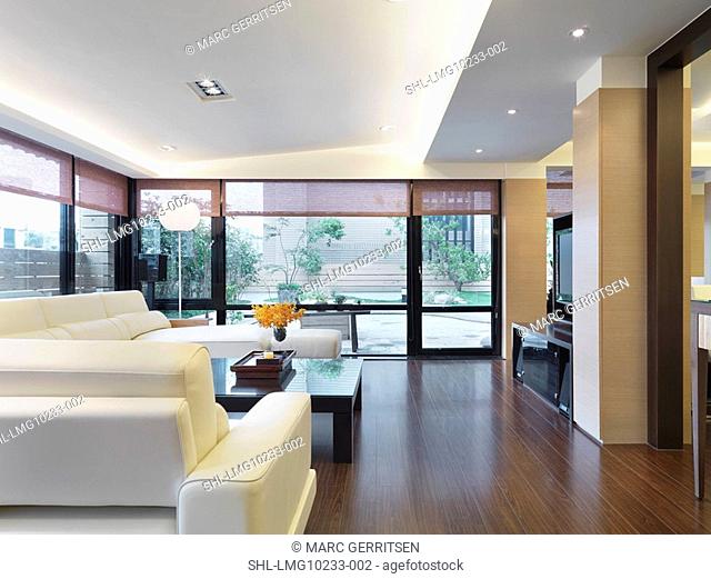 White furniture in modern living room with hardwood floors