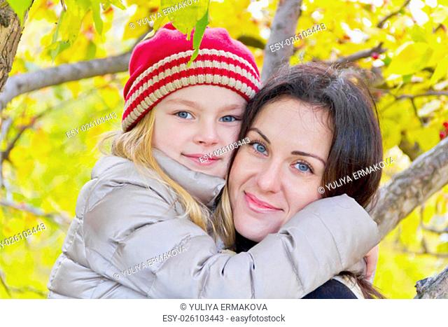 Portrait of happy mother and daughter in autumn