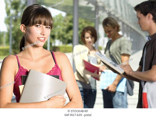 Smiling student holding folder