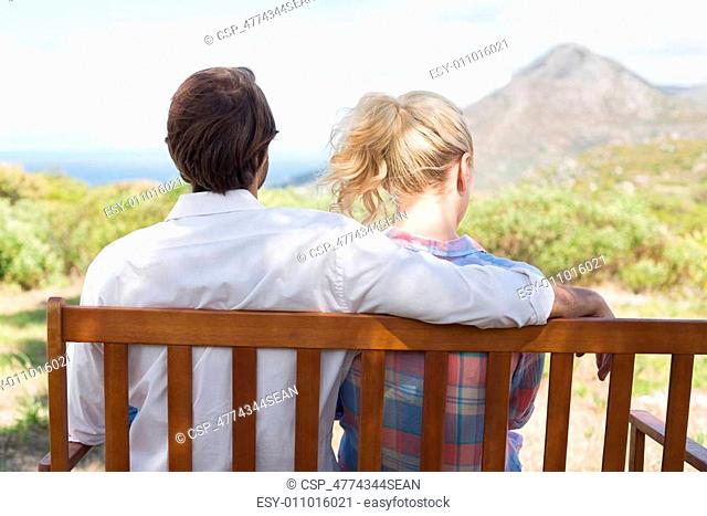 Cute couple sitting on bench together