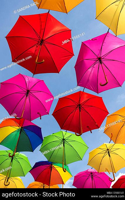 colorful umbrellas against a blue sky in Masevaux in Alsace, France