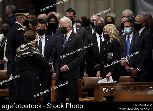 United States President Joe Biden, center left, greets Alma Powell, wife of Colin Powell, former secretary of state, left