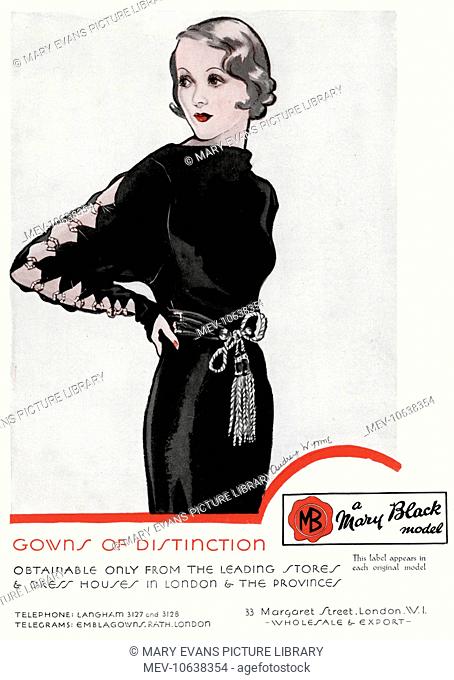 1930s black dress with high boat neckline, tassel belt around the waist and diamond shape holes down the long sleeves