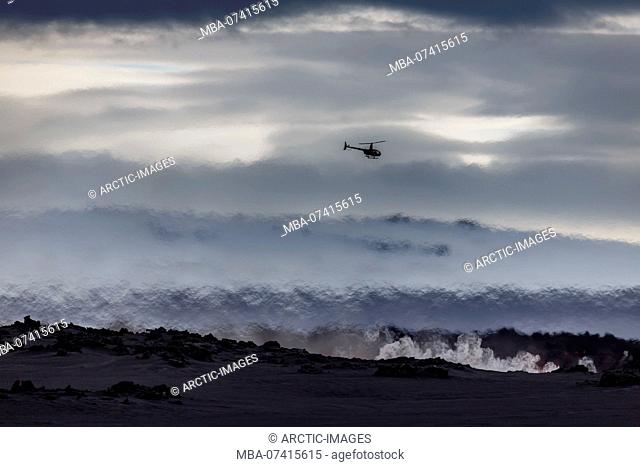 Helicopter flying over the volcano eruption at the Holuhruan Fissure, near the Bardarbunga Volcano, Iceland. August 29, 2014 a fissure eruption started in...