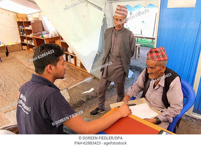 Dambar Bahadru Paraguli (R, 83) gets advice at the medical center of the Malteser relief organzation in Lamosanghu, Nepal, 19 October 2015
