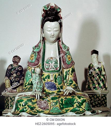 Chinese statuette of Kuan-Yin, the Taoist goddess of mercy, with some of the eight Taoist immortals, with biscuit and enamel decoration