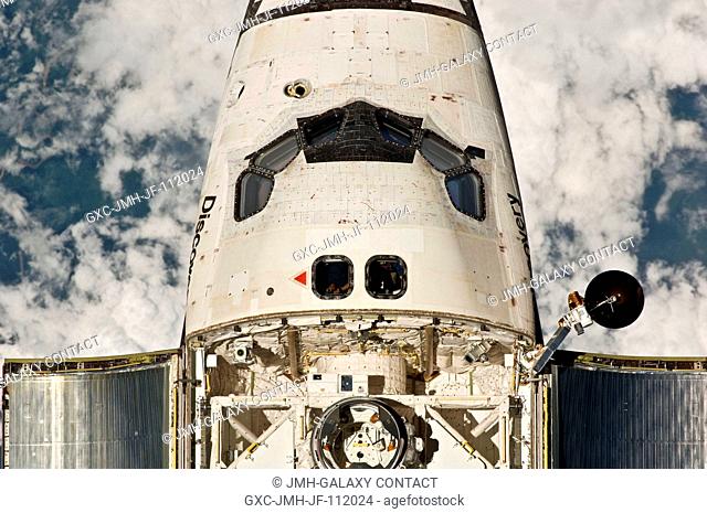 This view of the crew cabin and forward payload bay of the space shuttle Discovery was provided by an Expedition 26 crew member during a survey of the...