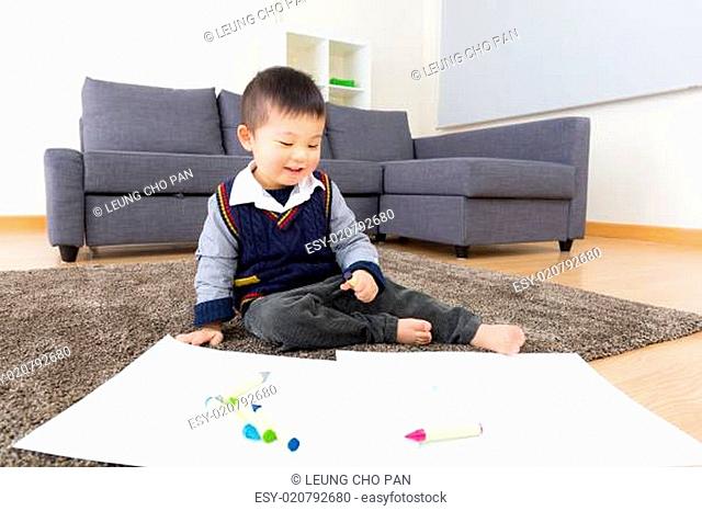 Little boy drawing picture at home
