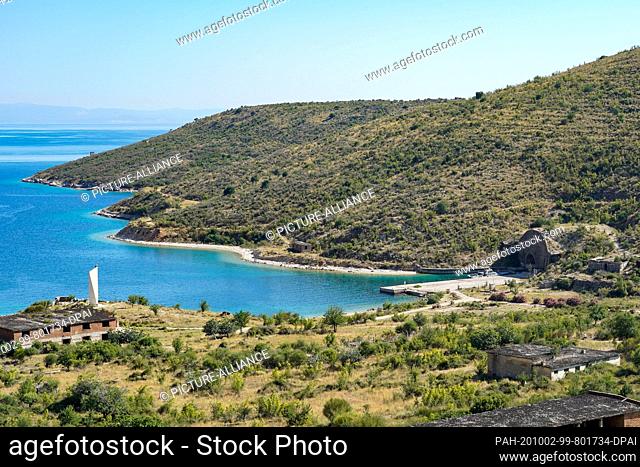 30 June 2020, Albania, Himarë: The former submarine bunker (r) of the Albanian and Soviet navy in the bay of Porto Palermo on the Adriatic Sea south of Himara...