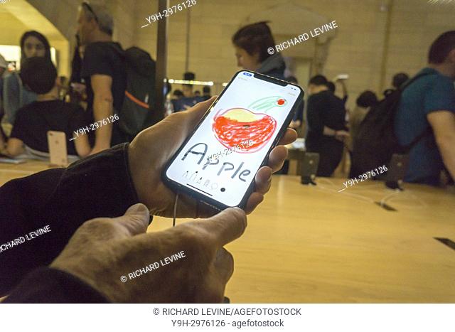 A customer in the Apple store in Grand Central Terminal in New York her artwork created on the new iPhone X on Friday, November 3, 2017