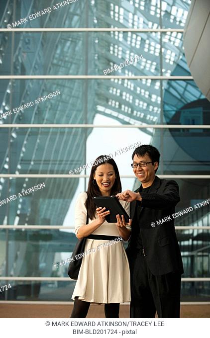 Asian business people using digital tablet