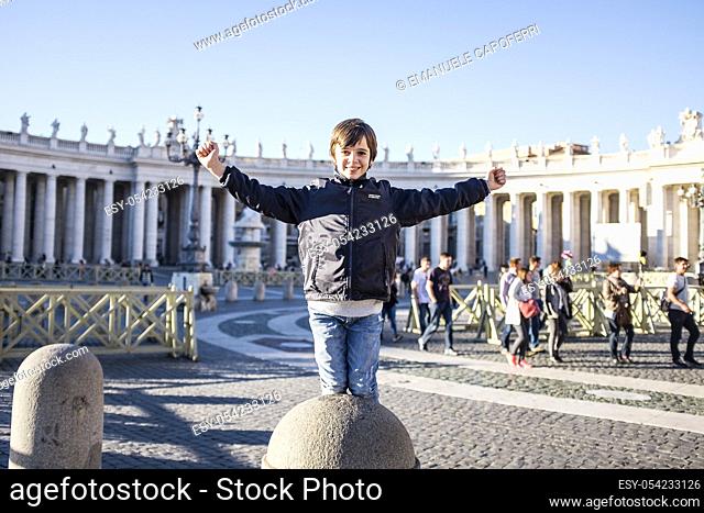 Child has fun in St Peter's Square in Rome, Italy