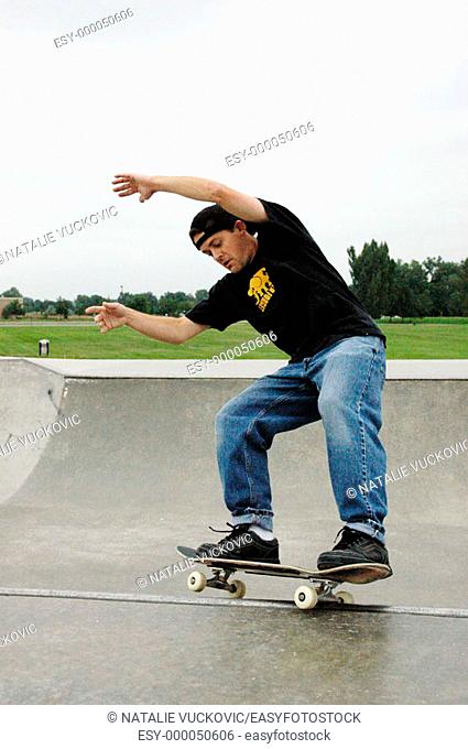 Skateboarder skating on the rim
