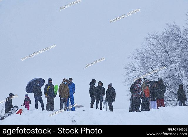 People playing with snowboard in a residential area of Mostoles on January 9, 2021 in Madrid. Spain is on red alert for a second day due to storm Filomena
