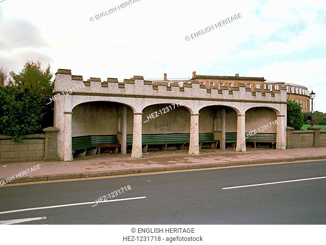 Shelter on Queen's Terrace, Fleetwood, Lancashire, 1999. This empty shelter containing benches is decorated with crenellations but appears to be pebble-dashed