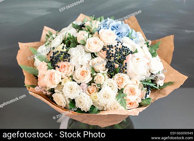 Rich bunch of peonies, roses and blue hydrangea flowers, green leaf. Fresh spring bouquet. Summer Background. Selective focus