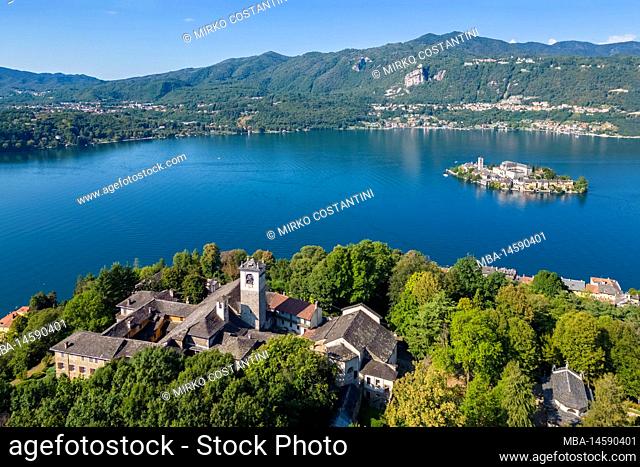 Aerial view of the Sacro Monte di Orta and Isola di San Giulio on Lake Orta in the summer. Orta Lake, Province of Novara, Piedmont, Italy