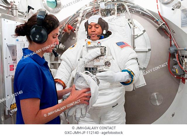 NASA astronaut Alvin Drew, STS-133 mission specialist, participates in an Extravehicular Mobility Unit (EMU) spacesuit fit check in the Space Station Airlock...