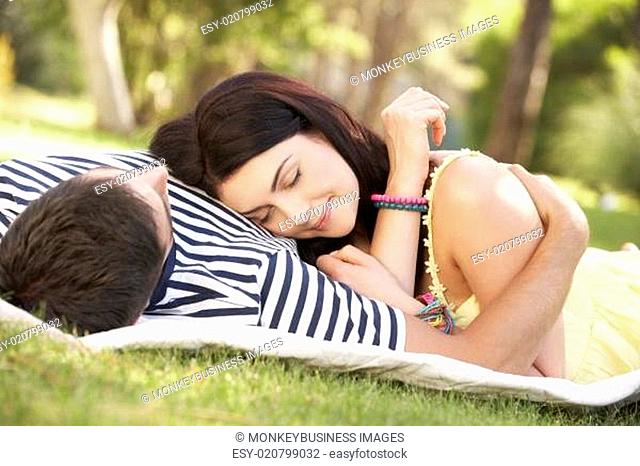 Couple Relaxing Together In Garden