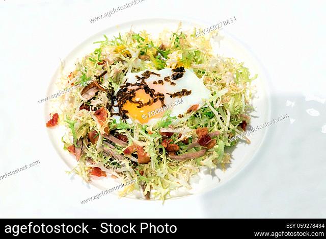 Egg salad with duck confit, groumet French Cuisine