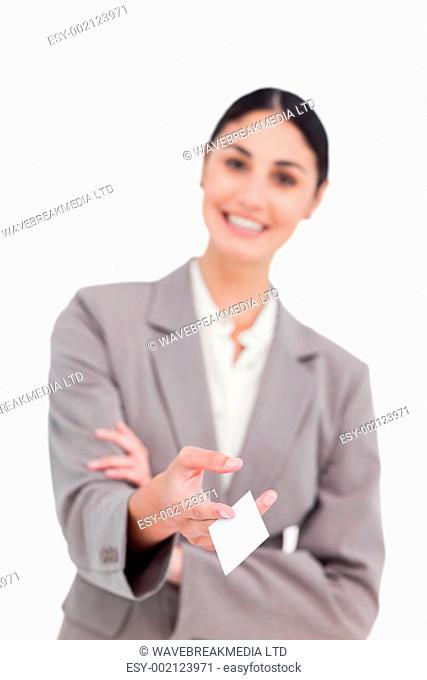 Business card being handed over by smiling saleswoman against a white background