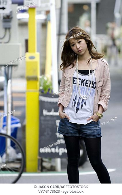 Japanese Girl poses on the street in Machida, Japan. Machida is an