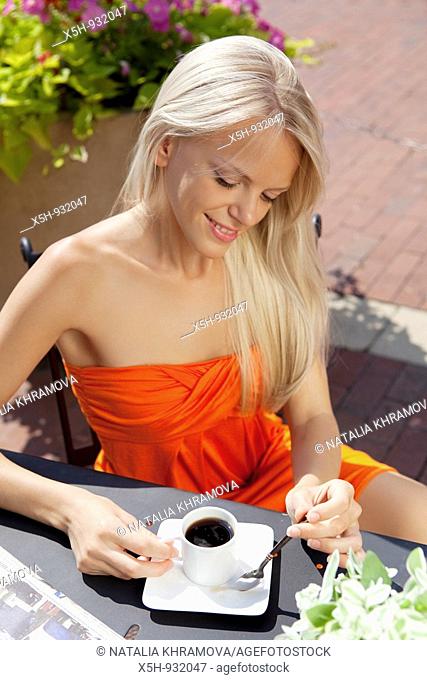one young woman drinking coffe outdoor