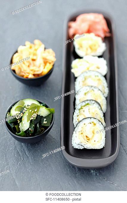 Sushi with squid in tempura, wakame and kimchi salads