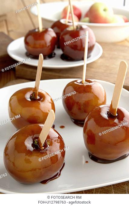 Toffee apples on white plates