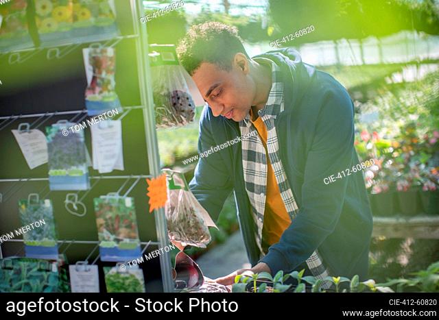 Man shopping for plant seeds in garden center