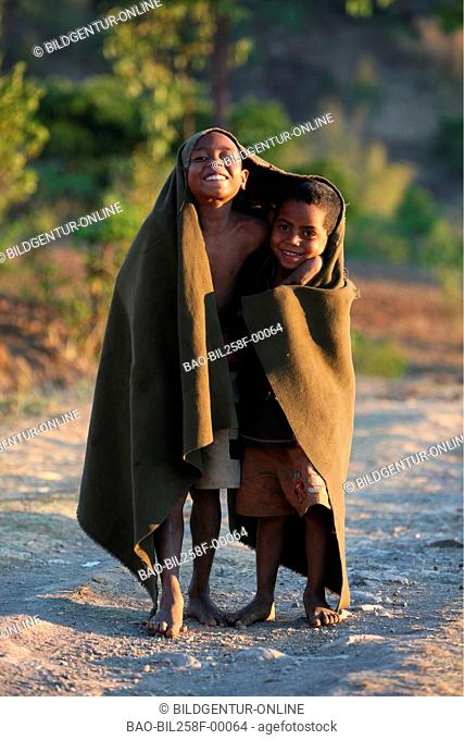 Boys in a mountain village in the scenery with poor bites of the mountain region to the south of Dili of the capital of the east Timor with Tutuala