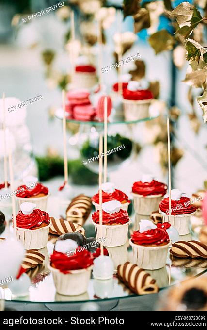 Dessert Sweet Tasty Cupcakes And Cookies In Candy Bar On Table. Delicious Sweet Buffet. Wedding Decorations