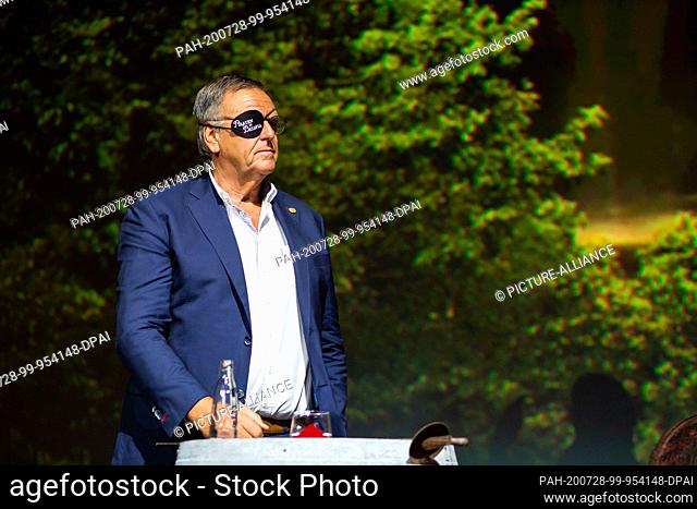 28 July 2020, Baden-Wuerttemberg, Rust: Roland Mack, managing partner of Europa-Park, stands with an eye patch on the podium in a cinema on the Europa-Park...