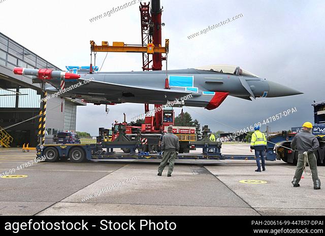 dpatop - 16 June 2020, Bavaria, Lagerlechfeld: A Eurofighter is lifted by a crane in the Lechfeld Barracks. The fighter is to be used in Kaufbeuren to train...