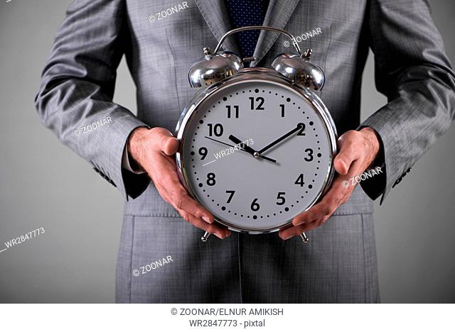 Businessman with clock in business concept