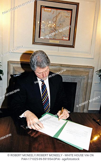 United States President Bill Clinton signs federal disaster declarations for Oregon and Washington in the Map Room of the White House in Washington
