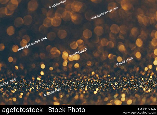 Blur neon gold light circle background. Sparkling firework bokeh dots in retro film filter style. Luxury and classy new year and christmas party textured...