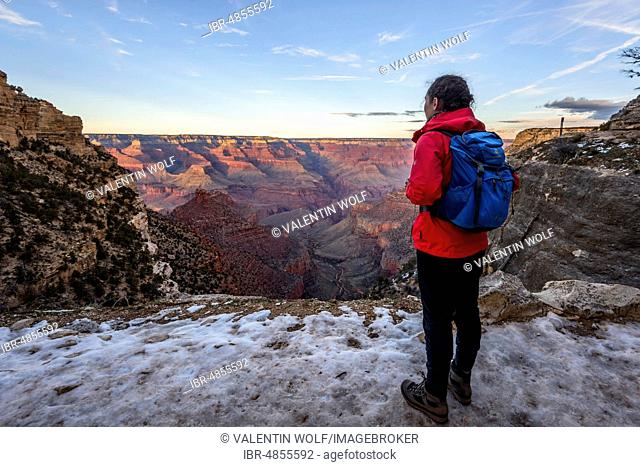 Young woman looking into the gorge of the Grand Canyon, view from the Bright Angel Trail, eroded rock landscape, South Rim, Grand Canyon National Park