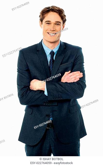 Happy young businessman smiling at the office