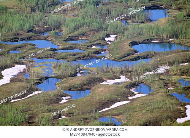 RUSSIA - semi-tundra. Lakes and melting snow, aerial. Taiga near Norilsk town, Russian Arctic