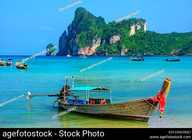 Longtail boat anchored at Ao Loh Dalum beach on Phi Phi Don Island, Krabi Province, Thailand. Koh Phi Phi Don is part of a marine national park