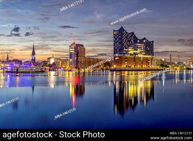 View over the Elbe to the illuminated Hamburg harbor with the Elbe Philharmonic Hall