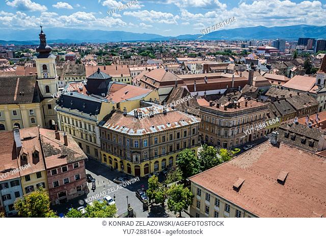 Aerial view with Holy Trinity Church and City Hall from Lutheran Cathedral of Saint Mary in Historic Center of Sibiu city of Transylvania, Romania