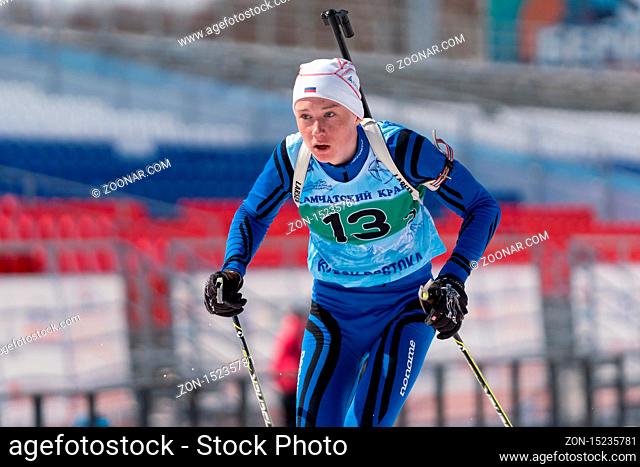 Kamchatka sportsman biathlete Protasov Dmitry skiing on ski track distance biathlon stadium. Junior biathlon competitions East of Cup