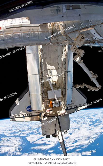 Backdropped by Earth's horizon and the blackness of space, the docked space shuttle Atlantis is featured in this image photographed by an Expedition 23 crew...