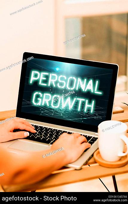 Text sign showing Personal Growth. Business approach improve develop your skills qualities Learn new materials Both Hands Typing On Laptop Next To Cup And Plant...