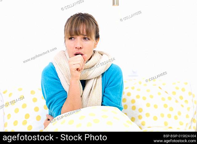A young woman in bed suffering from a flu-like condition